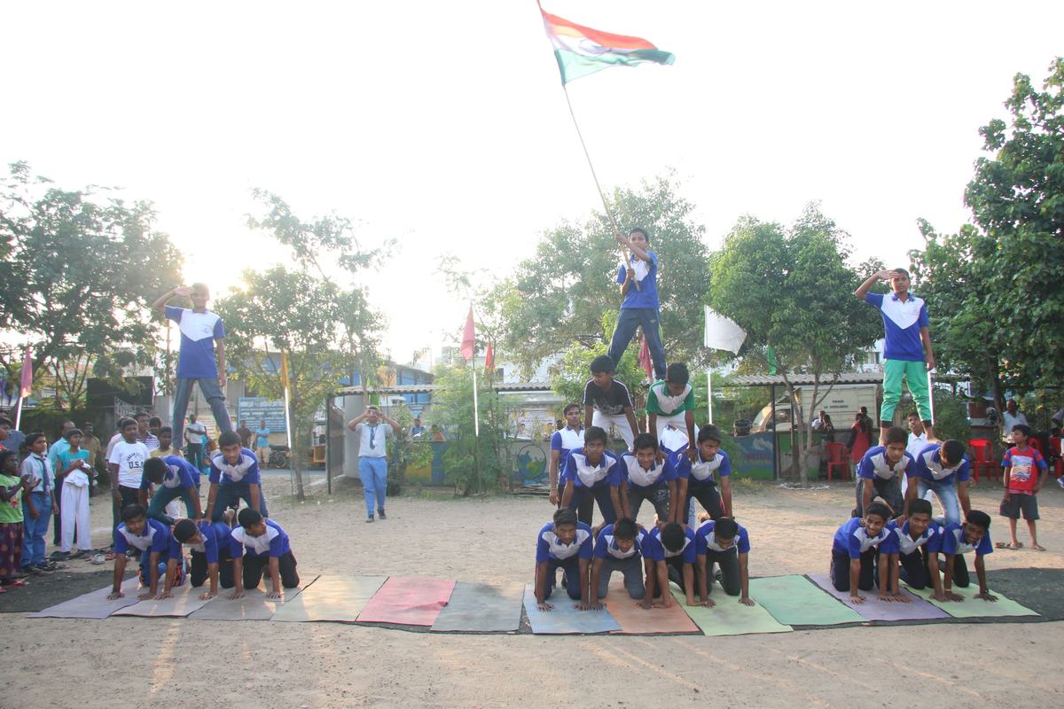 Students form a human pyramid with the national flag at the school sports day